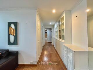 Spacious hallway with wooden flooring and built-in shelving