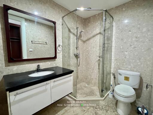 Modern bathroom with shower enclosure, toilet, and sink