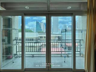 Balcony with glass doors and city view