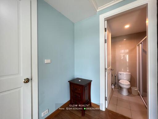 Small bedroom corner with an adjacent bathroom