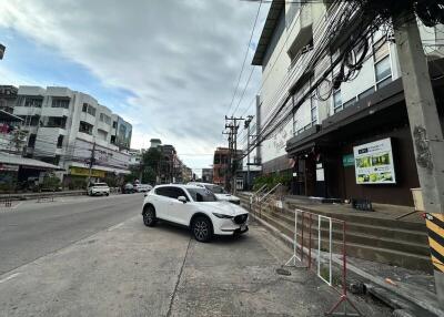 Street view of a building with parked cars