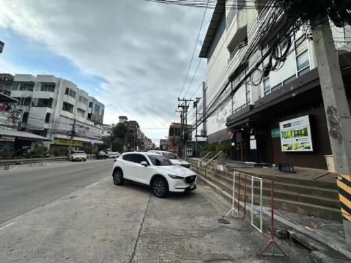 Street view of a building with parked cars