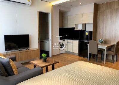 Modern studio apartment with open living area and kitchen