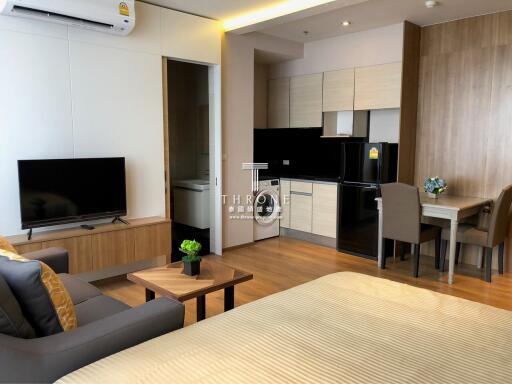 Modern studio apartment with open living area and kitchen