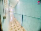 Bright corridor with blue-painted walls and patterned floor tiles