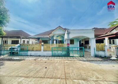 Front exterior view of residential building with driveway and gate