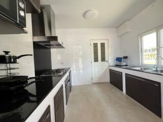 Modern kitchen with dark cabinets and white countertops