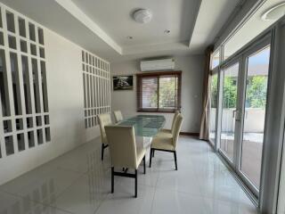 Bright and modern dining area with glass table and large windows