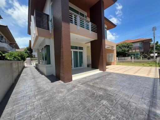 Front view of a modern house with driveway and balcony