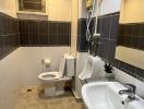 Bathroom with sink, toilet, urinal, and shower