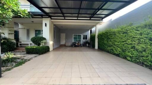 Covered carport with greenery and entrance to house