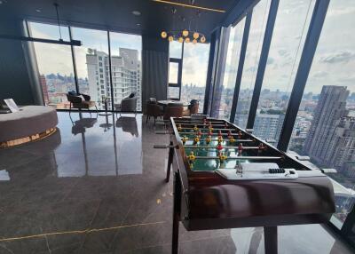 Recreational room with panoramic city views and foosball table