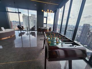 Recreational room with panoramic city views and foosball table