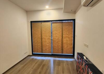 Simple living room with wooden floor and large window