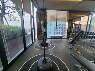 Indoor gym area with exercise equipment and city view