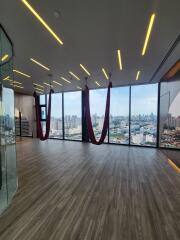 Panoramic city view from a spacious room with suspended hammocks