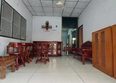 Living room with wooden furniture and tiled floor