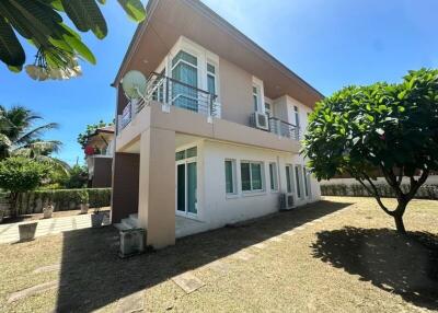 Exterior view of a two-story house with a well-maintained yard