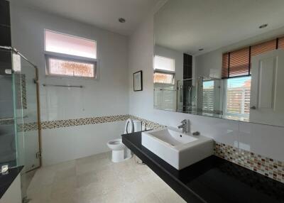 Spacious modern bathroom with large sink and shower area