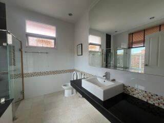 Spacious modern bathroom with large sink and shower area