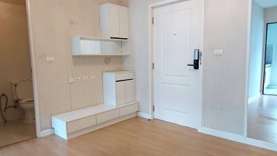 Modern apartment entryway with white storage cabinets