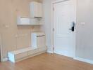 Modern apartment entryway with white storage cabinets