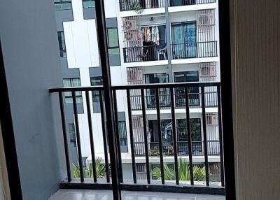 View of a balcony and adjacent building from a living space