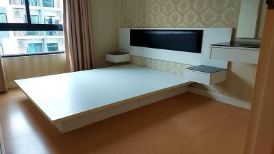 Empty bedroom with a window, wall-mounted headboard, and floating nightstands