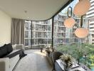 Modern living room with large curved windows and city view