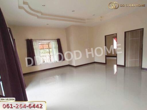 Spacious living room with large windows and glossy tiled flooring