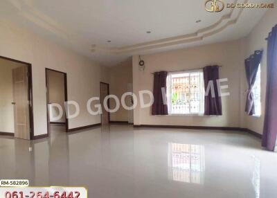 Spacious living room with large windows and clean flooring