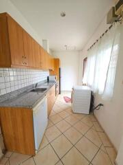 Modern kitchen with wooden cabinets and tiled floor