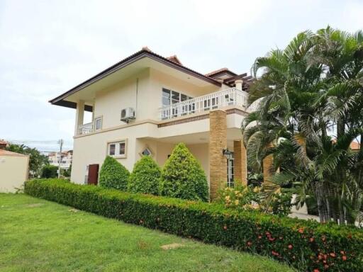 Exterior view of a two-story house with garden