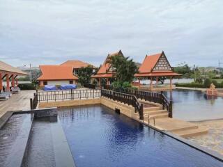 Scenic outdoor pool area with traditional-style buildings