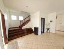 Spacious and bright house entryway with wooden staircase