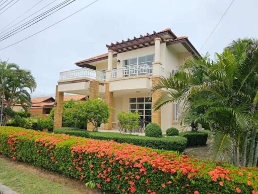 Exterior view of a two-story house with a well-maintained garden