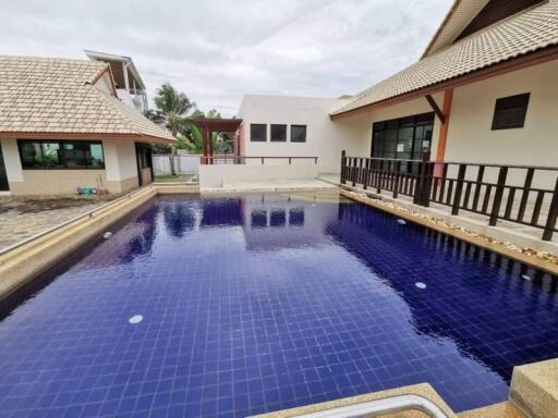 Outdoor swimming pool area with surrounding buildings