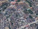 Aerial view of a neighborhood with roads, buildings, and a medical clinic