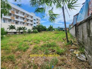 vacant land with building in background