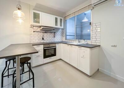 Modern kitchen with white cabinets and a breakfast bar