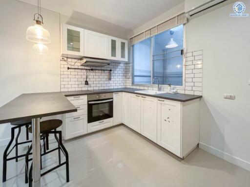 Modern kitchen with white cabinets and a breakfast bar