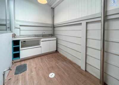 Laundry room with wooden floor and sink