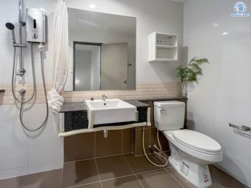 Modern bathroom with sink, toilet, and shower