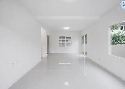 Bright empty room with large windows and tiled floors