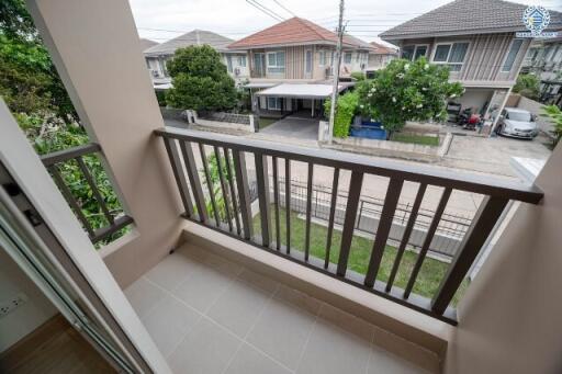 Balcony view of residential neighborhood with houses and trees