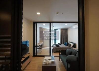 modern living room with TV area and open view towards the bedroom