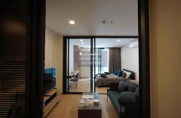 modern living room with TV area and open view towards the bedroom