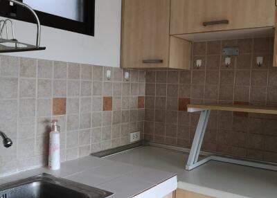 Modern kitchen with tiled backsplash and wooden cabinets