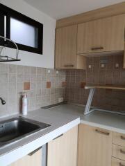 Modern kitchen with tiled backsplash and wooden cabinets