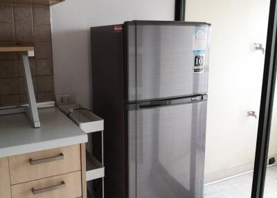 Modern kitchen with refrigerator and sliding glass door